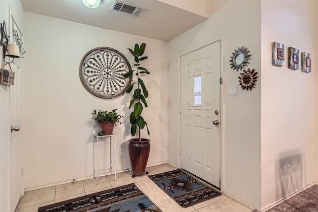 12828 Starbrimson Trl, Elgin, TX 78621 - entrance foyer featuring light tile patterned floors and baseboards