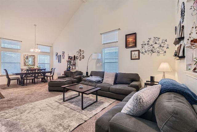 12828 Starbrimson Trl, Elgin, TX 78621 - living area with high vaulted ceiling, a chandelier, and carpet floors