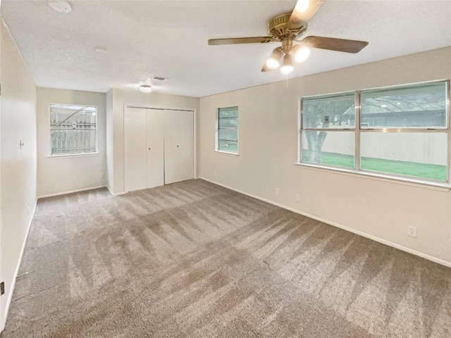 6234 Hillston Dr, Austin, TX 78745 - unfurnished bedroom featuring carpet, a closet, and a ceiling fan