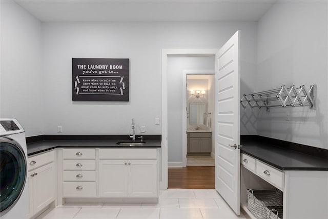 1821 Overland Stage Rd, Dripping Springs, TX 78620 - laundry area with washer / dryer, cabinet space, and light tile patterned floors