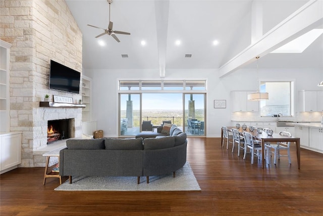 1821 Overland Stage Rd, Dripping Springs, TX 78620 - living room with high vaulted ceiling, a ceiling fan, dark wood-type flooring, and a fireplace