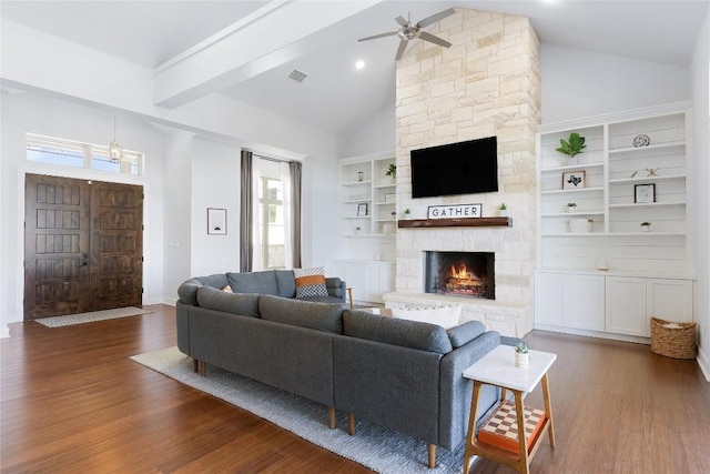 1821 Overland Stage Rd, Dripping Springs, TX 78620 - living room featuring a ceiling fan, dark wood-style floors, a fireplace, built in shelves, and baseboards