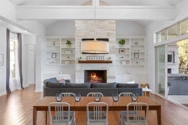 1821 Overland Stage Rd, Dripping Springs, TX 78620 - living area with wood finished floors, a fireplace, and healthy amount of natural light