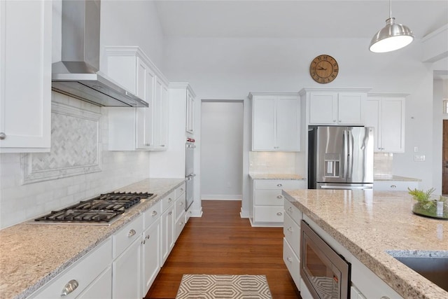 1821 Overland Stage Rd, Dripping Springs, TX 78620 - kitchen featuring wall chimney range hood, appliances with stainless steel finishes, white cabinets, backsplash, and baseboards