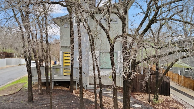 view of side of property featuring a wooden deck