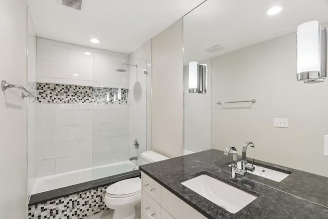 full bathroom with vanity, toilet, and tiled shower / bath combo