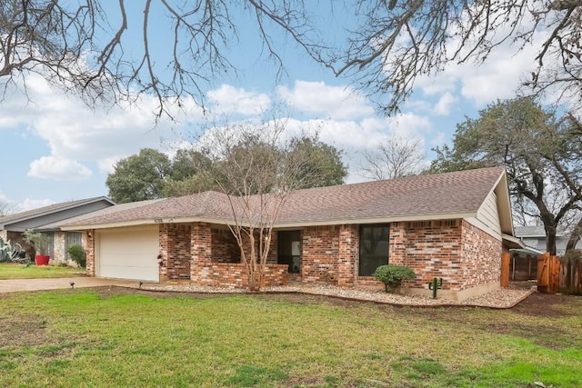 ranch-style house featuring a garage and a front lawn