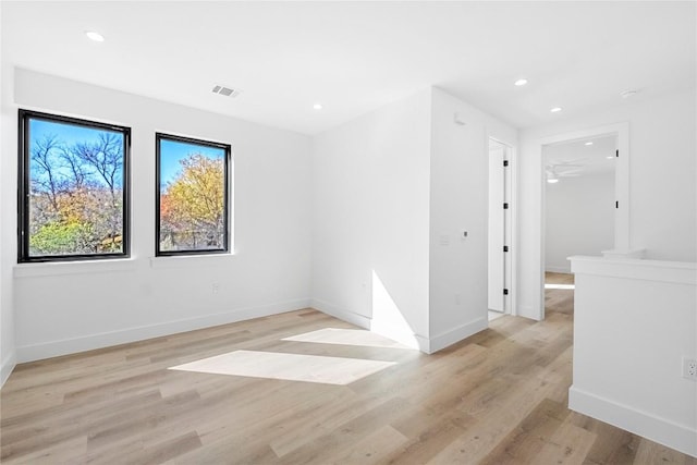 spare room with light wood-type flooring