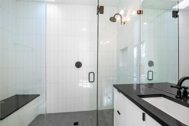 bathroom with vanity and a shower with door