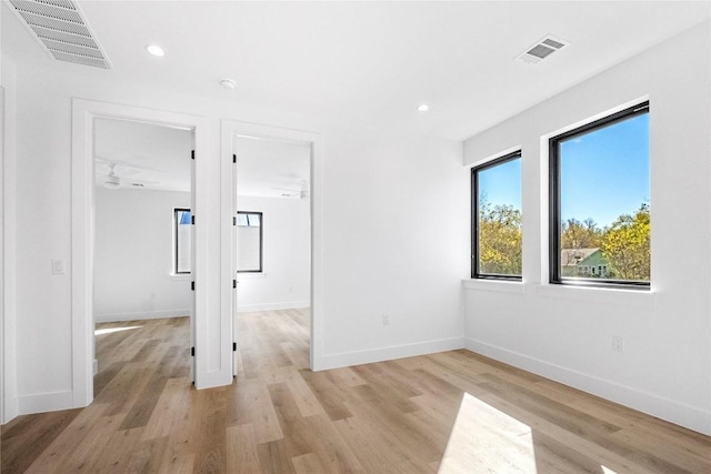 empty room with light hardwood / wood-style flooring