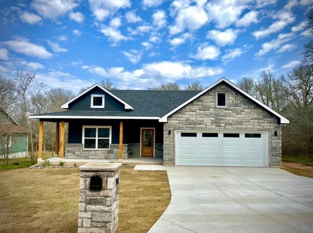 view of front of home with a garage, a front lawn, and a porch