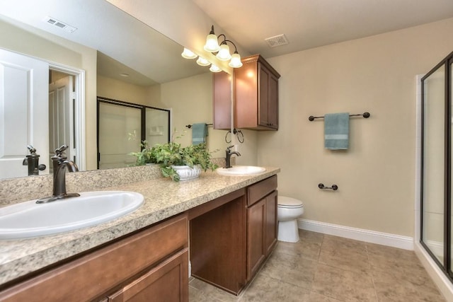 bathroom featuring vanity, tile patterned flooring, a shower with shower door, and toilet