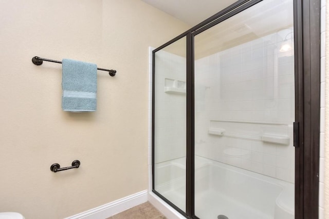 bathroom with a shower with door