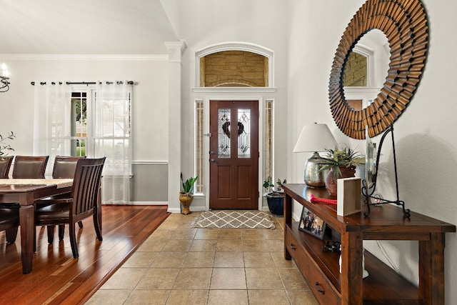 entryway featuring crown molding and wood-type flooring