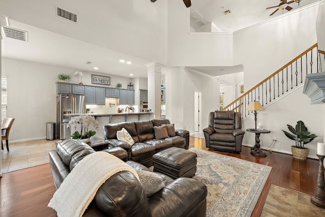 2621 Golden Gate Park, Austin, TX 78732 - living room featuring hardwood / wood-style floors, a towering ceiling, decorative columns, and ceiling fan