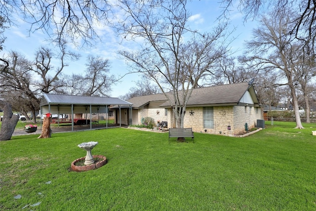 back of house featuring central AC and a yard