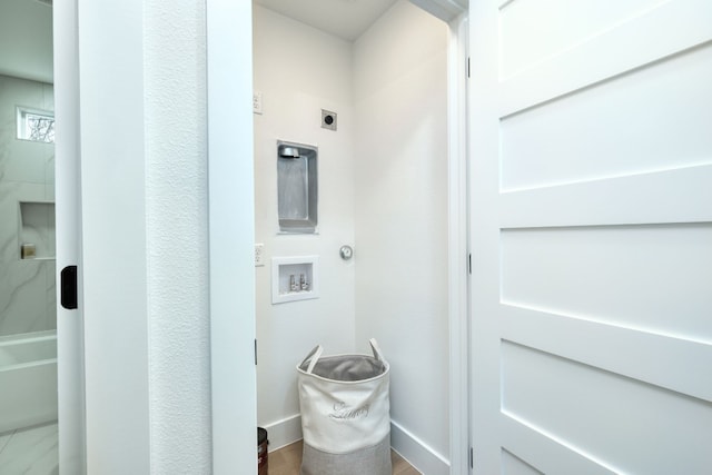 908 E 51st St, Austin, TX 78751 - laundry room featuring hookup for an electric dryer, washer hookup, baseboards, and wood finished floors