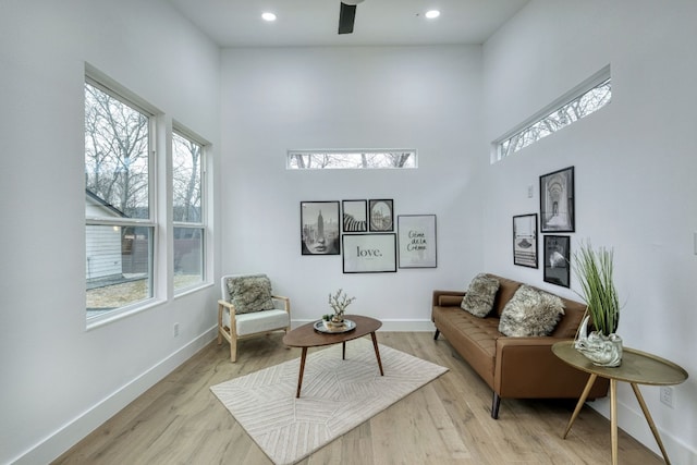 908 E 51st St, Austin, TX 78751 - living room featuring healthy amount of natural light, a high ceiling, baseboards, light wood-style floors, and recessed lighting