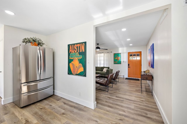 kitchen with stainless steel fridge and light wood-type flooring