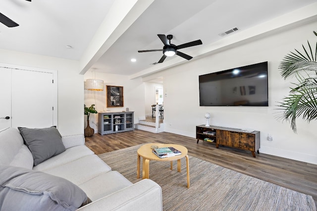 living room with ceiling fan and dark hardwood / wood-style flooring