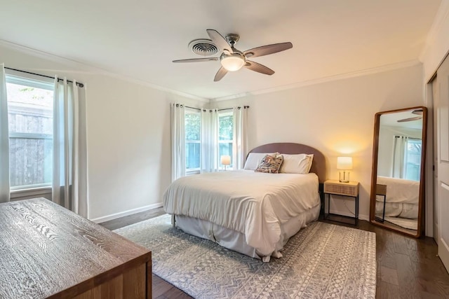 1713 Mariposa Dr, Austin, TX 78741 - bedroom with multiple windows, dark wood-style flooring, ornamental molding, and a ceiling fan