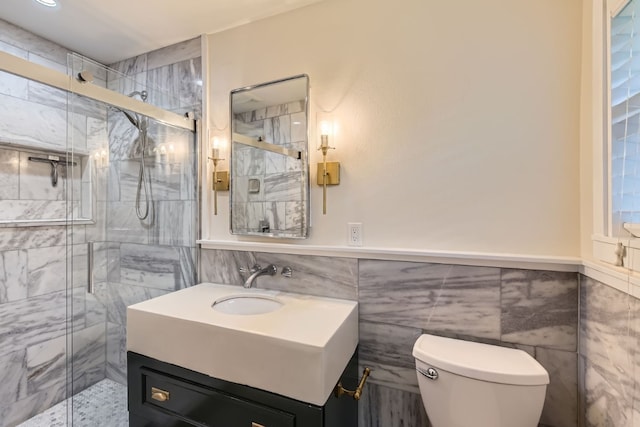 1713 Mariposa Dr, Austin, TX 78741 - bathroom with tile walls, vanity, a stall shower, and wainscoting