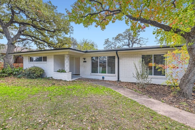 1713 Mariposa Dr, Austin, TX 78741 - mid-century inspired home with brick siding and a front lawn