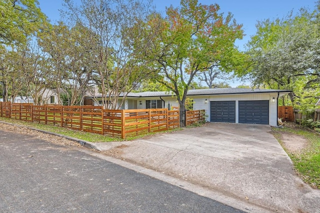 1713 Mariposa Dr, Austin, TX 78741 - view of front facade featuring a fenced front yard, driveway, and an attached garage