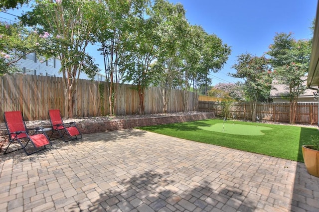 123 Parque Vista Dr, Georgetown, TX 78626 - fenced backyard featuring an area to practice putting and a patio