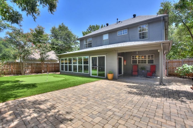 123 Parque Vista Dr, Georgetown, TX 78626 - back of house with an area to practice putting, a patio, and a fenced backyard