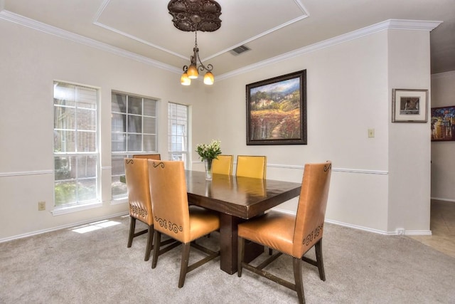 dining space featuring an inviting chandelier, crown molding, and light colored carpet