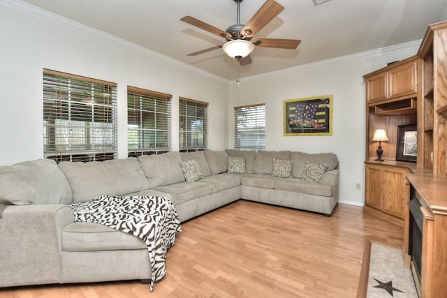 living room featuring ornamental molding, light hardwood / wood-style floors, and ceiling fan