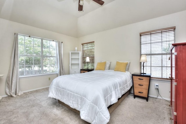 bedroom featuring multiple windows, lofted ceiling, light colored carpet, and ceiling fan