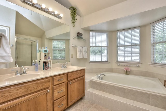 bathroom with vaulted ceiling, vanity, separate shower and tub, and tile patterned flooring