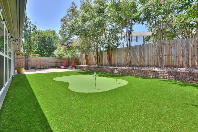 123 Parque Vista Dr, Georgetown, TX 78626 - fenced backyard featuring an area to practice putting and a patio