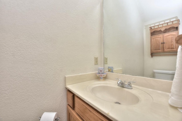 123 Parque Vista Dr, Georgetown, TX 78626 - bathroom featuring a textured wall, vanity, and toilet