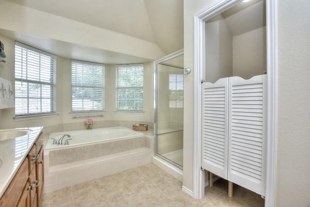 bathroom with lofted ceiling, vanity, plus walk in shower, and tile patterned flooring