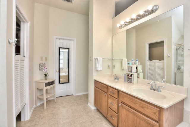 123 Parque Vista Dr, Georgetown, TX 78626 - full bath featuring a closet, tile patterned flooring, double vanity, a stall shower, and baseboards