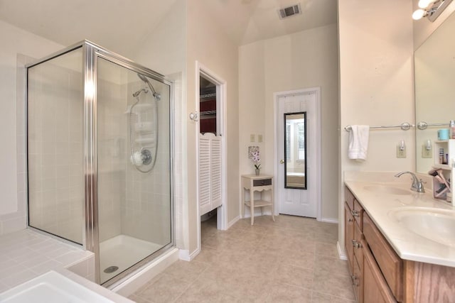 bathroom with vanity, a shower with shower door, and tile patterned flooring