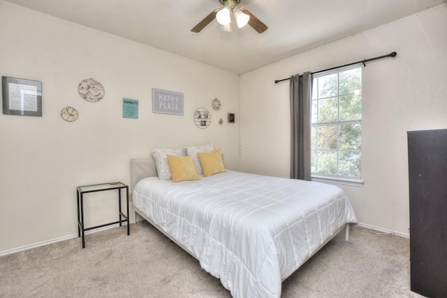 carpeted bedroom featuring ceiling fan and multiple windows