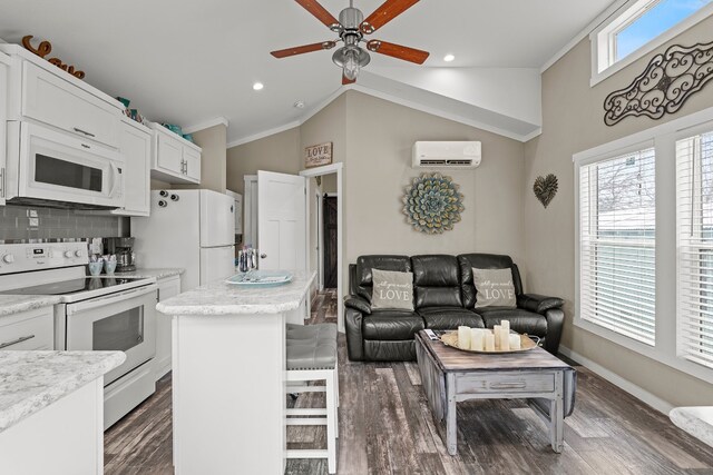 13006 Ranch Rd Unit 2341, Burnet, TX 78611 - kitchen with white appliances, a wall mounted air conditioner, ceiling fan, ornamental molding, and a kitchen island