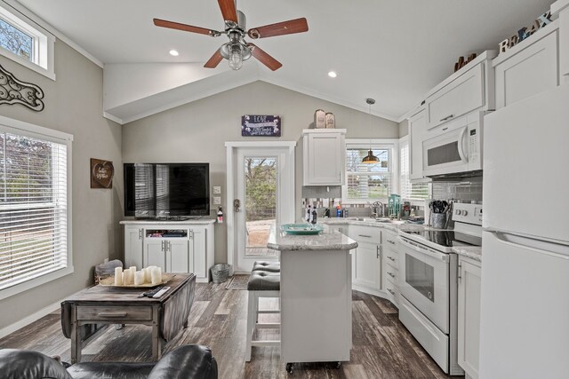 13006 Ranch Rd Unit 2341, Burnet, TX 78611 - kitchen featuring white appliances, white cabinetry, a ceiling fan, tasteful backsplash, and vaulted ceiling