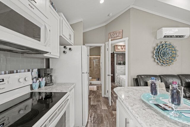 13006 Ranch Rd Unit 2341, Burnet, TX 78611 - kitchen with white appliances, a wall unit AC, crown molding, white cabinetry, and light stone counters