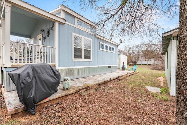 view of property exterior featuring covered porch