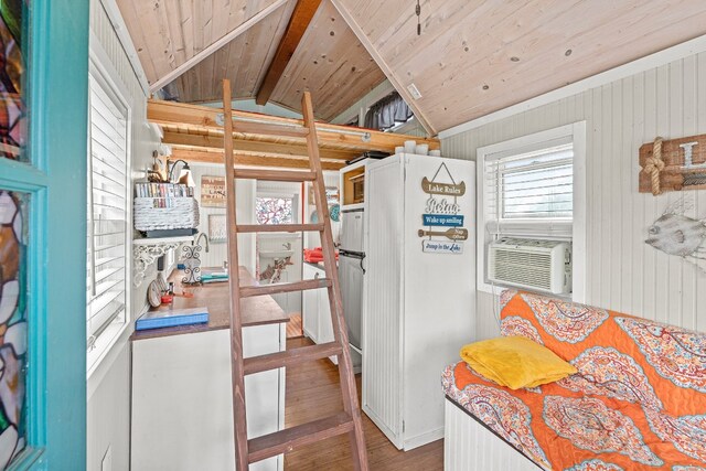 13006 Ranch Rd Unit 2341, Burnet, TX 78611 - kitchen with vaulted ceiling, wood ceiling, freestanding refrigerator, wood finished floors, and wooden walls