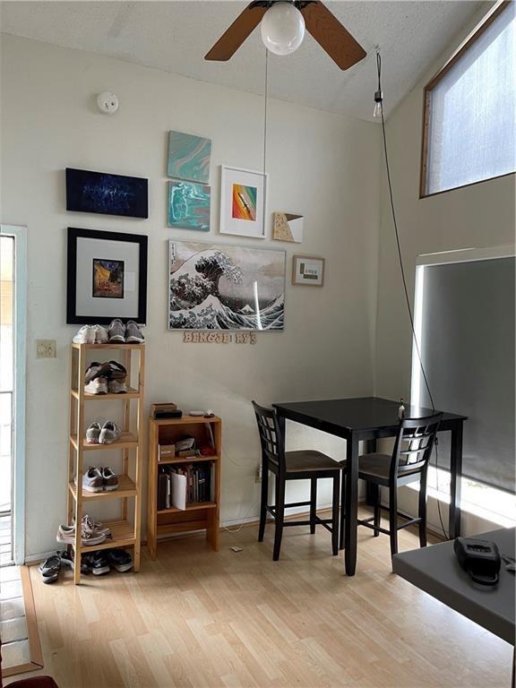 dining space featuring ceiling fan and light wood-type flooring