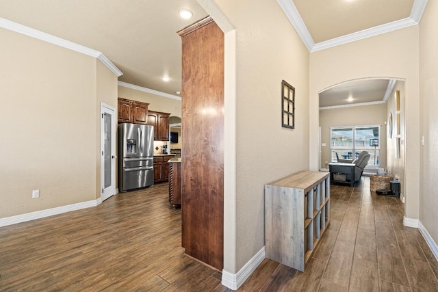 hallway with dark wood-type flooring and ornamental molding