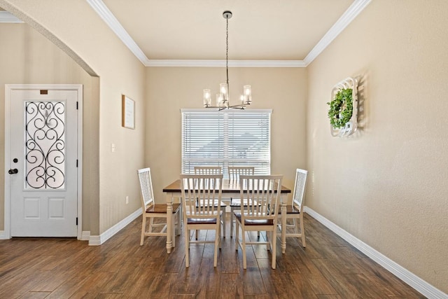 dining space featuring ornamental molding, dark hardwood / wood-style floors, and a chandelier