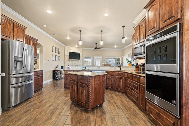 kitchen with crown molding, kitchen peninsula, a kitchen island, pendant lighting, and stainless steel appliances