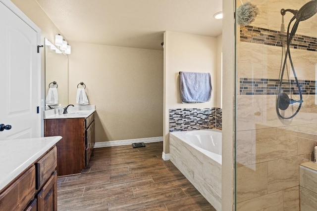 bathroom with vanity and independent shower and bath